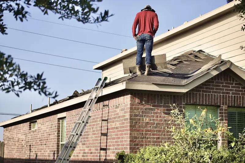 Professional roofer working on a residential roof in International Gardens